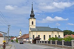 A főutca részlete a görögkatolikus templommal és a római katolikus templom tornyával