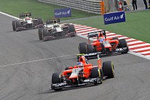 Photo de deux monoplaces Marussia et deux monoplaces HRT à Barheïn