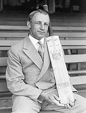 A cricketer holding a bat