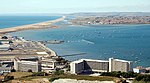 Sailing boats in Portland Harbour, seen from The Verne. The academy's clubhouse is on the far left.