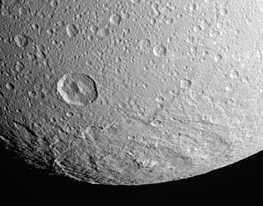 South polar impact basin Evander, 350 km in diameter, is by far the largest crater on Dione. The deep crater to its upper left is Sabinus.