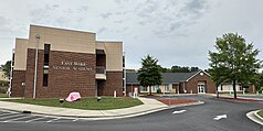 A multi-story set of beige and brick buildings