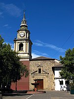 Church with a bell tower and a fountain in front