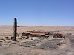 An abandoned factory building in a desert setting