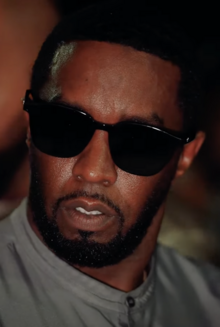 Headshot of Sean Combs. He is a middle-aged black man with short hair wearing sunglasses.