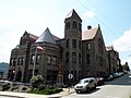 Carnegie Free Library of Braddock in Braddock, Pennsylvania, built in 1888 and designed by William Halsey Wood. The 1893 addition by Longfellow, Alden & Harlow is to the right of and including the octagonal tower.