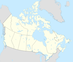 A yellow map of Canada with a red dot on the north side of Great Slave Lake