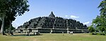 A terraced pyramid like structure with a stupa on top.