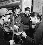 French-Canadian lumberjacks playing music while at camp