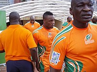 A close up shot of the Ivory Coast players, in their country's orange jerseys, entering the field from the dressing room tunnel.