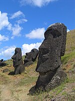 Several Moai sculptures on a slope