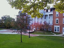 Picture of a four-story building with white columns