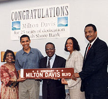 Photo of Obama and others carrying a street sign that reads "Honorary: Milton Davis Blvd."