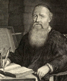 Engraving of a bearded man in a skull cap sitting at a desk and writing in a book with a quill pen.