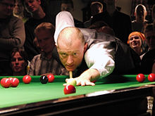 A man playing snooker