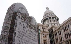 Picture of a large stone monument displaying the ten commandments with the Texas State Capitol in Austin in the background. The picture was part of a news release Wednesday, March second, 2005, by then Attorney General Abbott.