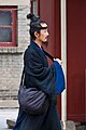 A Taoist man with a topknot and cross-collared robe.