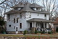 Image 1A wood-frame American Foursquare house in Minnesota with dormer windows on each side and a large front porch