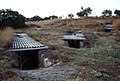 Chamber tombs at Aidonia, with corrugated iron sheets to protect the dromoi from erosion