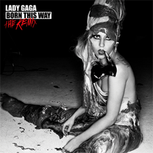 A greyscale image of Lady Gaga sitting on a liquid-like substance. Her body and head are wrapped with the same liquid-like substance and a shoe hangs from her mouth.