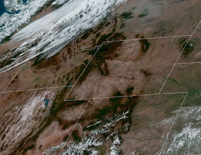 Satellite image of the western US including Washington, Idaho, Montana, Wyoming, and Colorado. Heavy smoke (in gray) is visible in central Idaho, and clouds are visible just northwest of the fires.