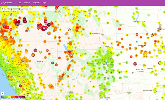 Map of PurpleAir particulate monitors shows mainly green in Colorado, indicating Good air quality conditions, while orange to red (Moderate to Unhealthy for Sensitive Groups) values are seen in Nebraska and Wyoming, and orange to purple colors are seen in Utah and Idaho, indicating that the Air Quality Index is reaching Unhealthy levels in some areas.