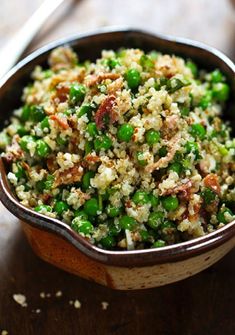 a bowl filled with rice and peas on top of a table