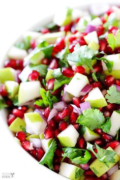 pomegranate, avocado and cilantro in a white bowl