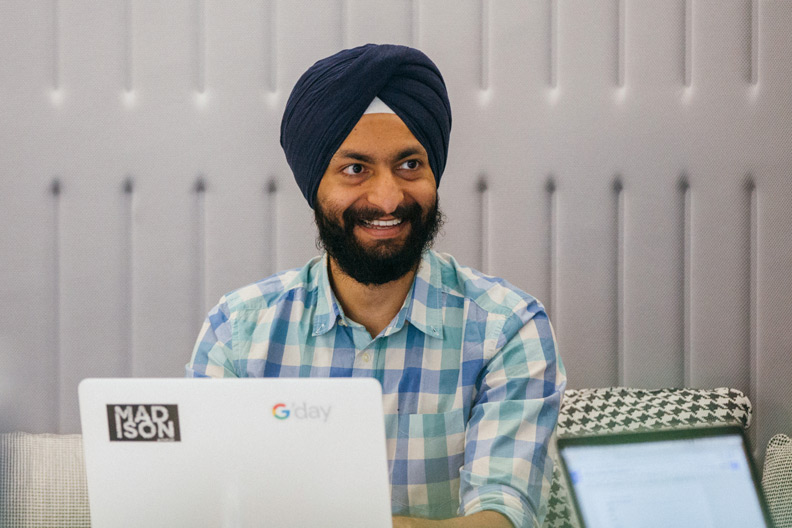 Man smiling in front of laptop