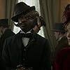 David Gyasi and Tamzin Merchant in Carnival Row (2019)