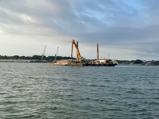 A tugboat and construction equipment on water.