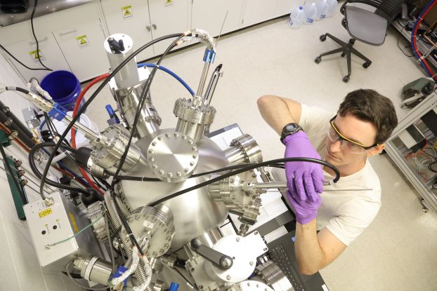 A student adjusts a piece of laboratory equipment