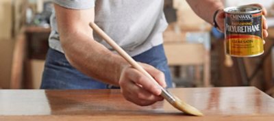 A man staining an interior surface. S-W product featured: Minwax Fast-Drying Polyurethane.