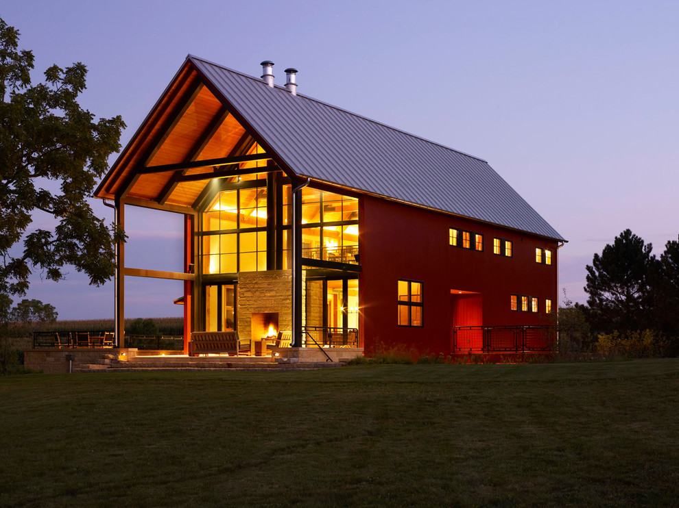 Example of a farmhouse red gable roof design in Milwaukee