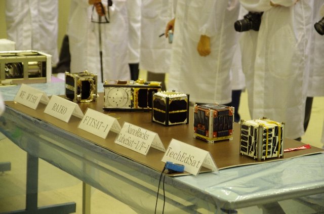 File:F-1 and other CubeSats at TKSC.jpg