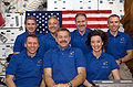 The crewmembers for the STS-125 mission pose for the traditional in-flight portrait on the middeck of Atlantis.