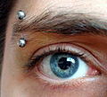 Vertical eyebrow piercing