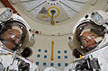 Grunsfeld and Feustel pose for a picture in the airlock of Atlantis prior to the mission's third spacewalk.