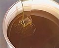 Pouring of maturated honey in pots.