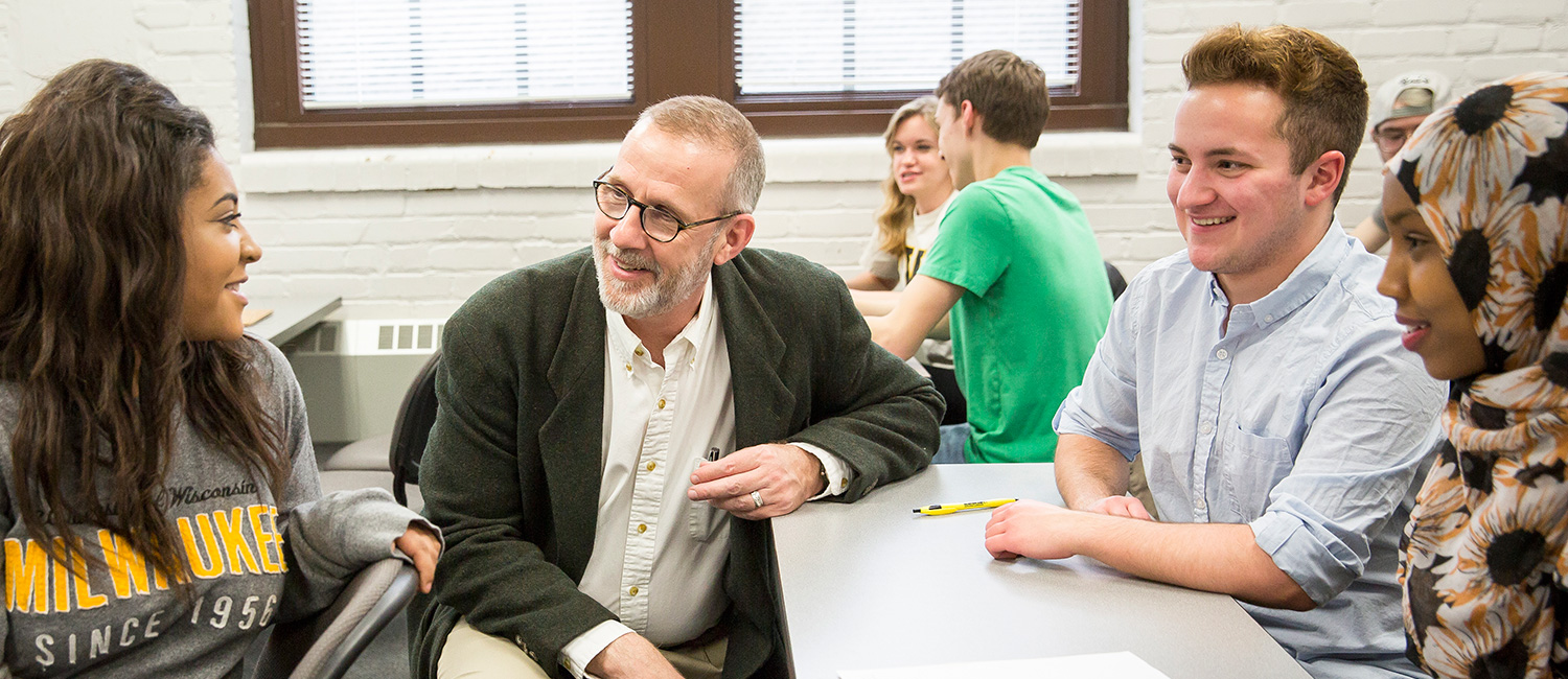 Students with a professor in a classroom setting