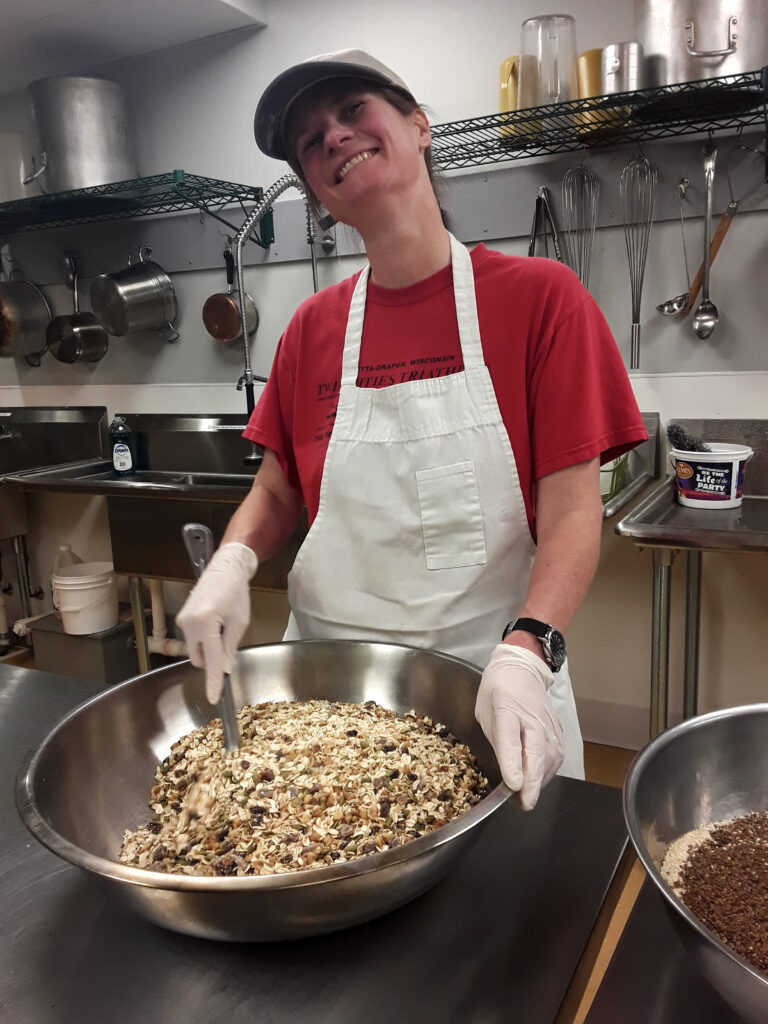 A woman mixes ingredients in a bowl