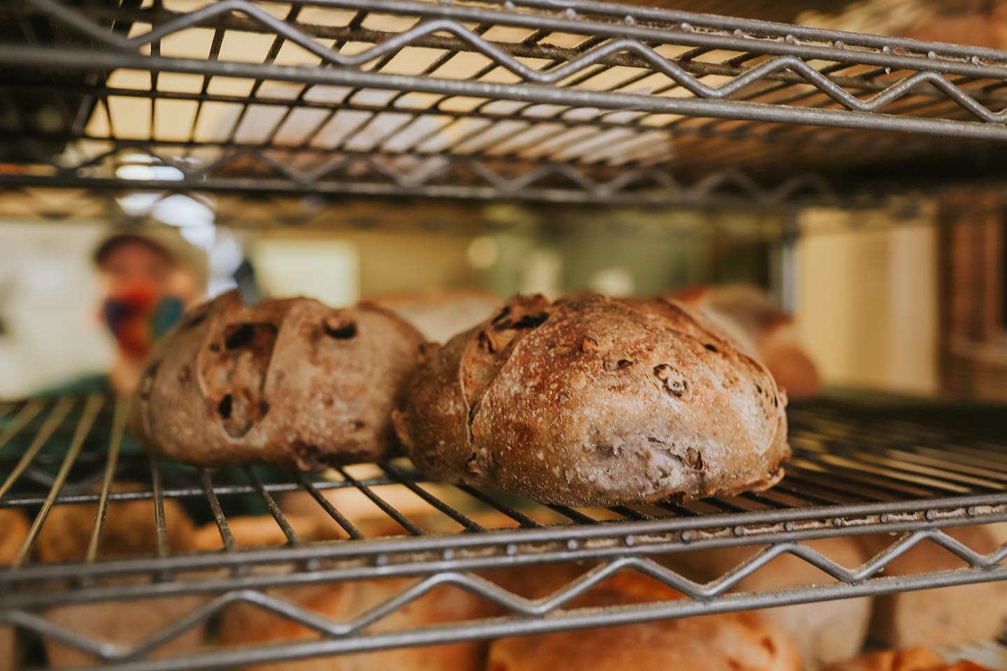 Several loaves on a shelf.