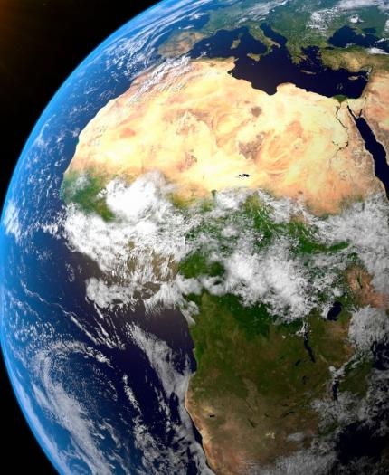 View of Earth from space showing the African continent and surrounding regions. The Sun is visible on the left.