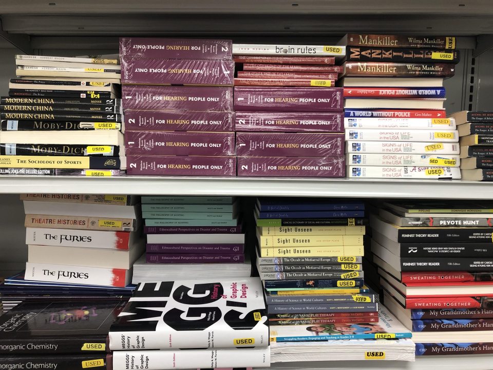 stacks of textbooks on shelves