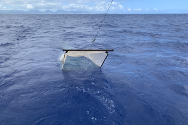 The right image shows the tucker trawl half submerged in the ocean with the sky visible in the background.